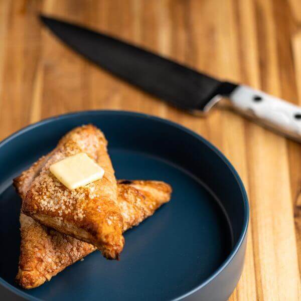 Forged 8" Chef's Knife with Ice Handle, shown in the background next to a pastry