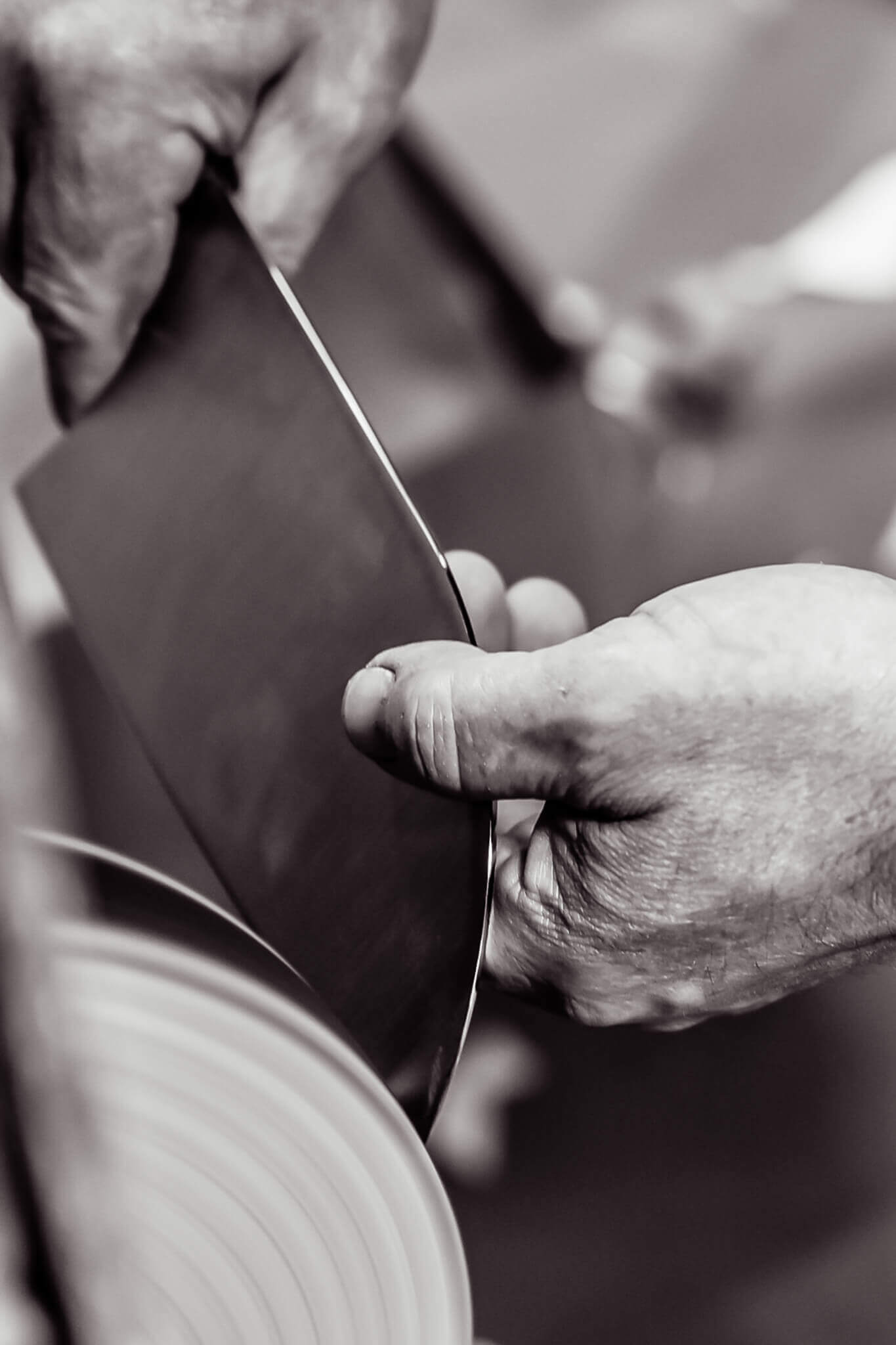 National Knife Month: Knife Angle Blog. Pictured is a cleaver being sharpened.
